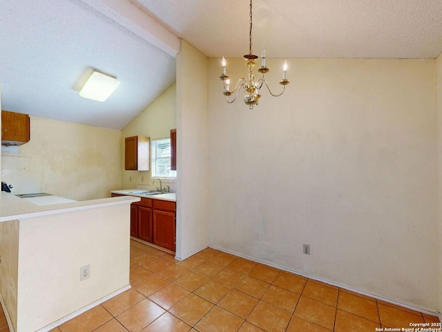 3415 Twining, San Antonio, TX 78211 - kitchen with lofted ceiling, light tile patterned flooring, a chandelier, light countertops, and decorative light fixtures