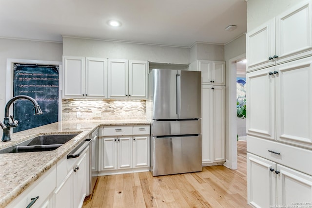 1332 Grey Oak Dr, San Antonio, TX 78213 - kitchen featuring freestanding refrigerator, white cabinets, light wood-style flooring, tasteful backsplash, and crown molding