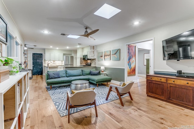 1332 Grey Oak Dr, San Antonio, TX 78213 - living area featuring a skylight, ceiling fan, light wood finished floors, recessed lighting, and crown molding