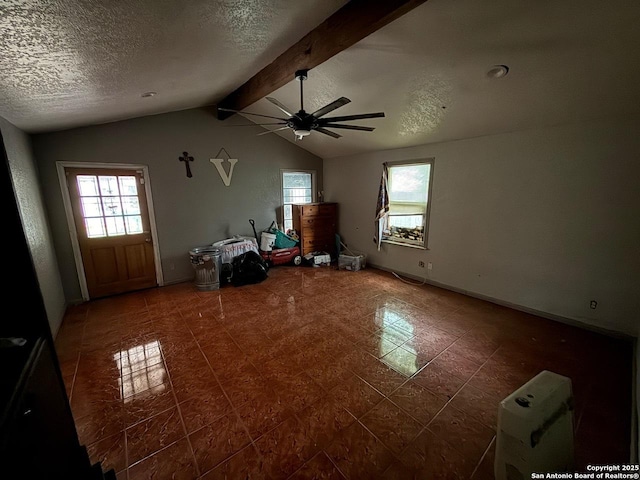 215 W Academy, San Antonio, TX 78226 - unfurnished living room featuring plenty of natural light, ceiling fan, a textured ceiling, and tile patterned flooring