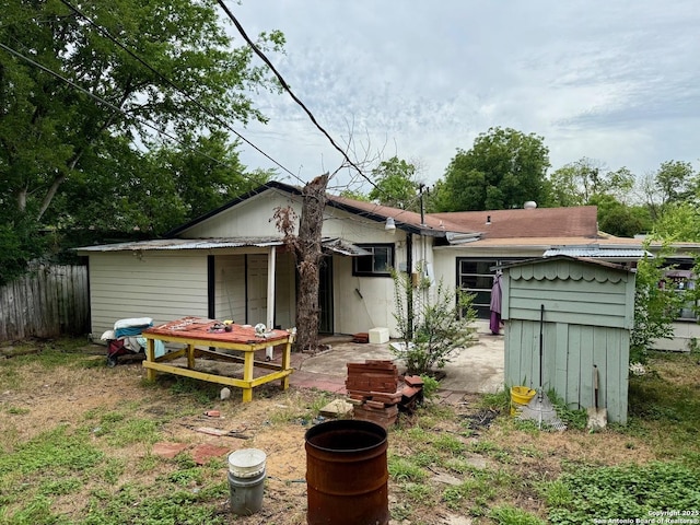 215 W Academy, San Antonio, TX 78226 - back of house with a storage shed and a patio
