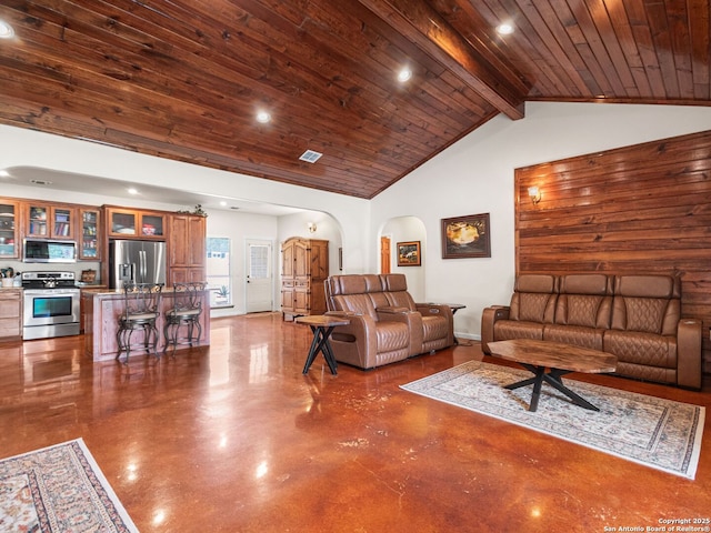 1131 Meadow Stream Rd, Spring Branch, TX 78070 - living area featuring finished concrete floors, arched walkways, recessed lighting, a wooden ceiling with exposed beams, and high vaulted ceiling