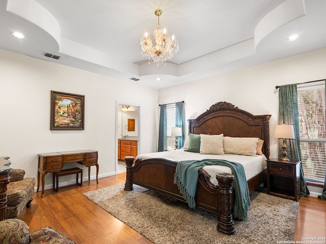 1131 Meadow Stream Rd, Spring Branch, TX 78070 - bedroom featuring a tray ceiling, wood finished floors, a chandelier, ensuite bathroom, and recessed lighting
