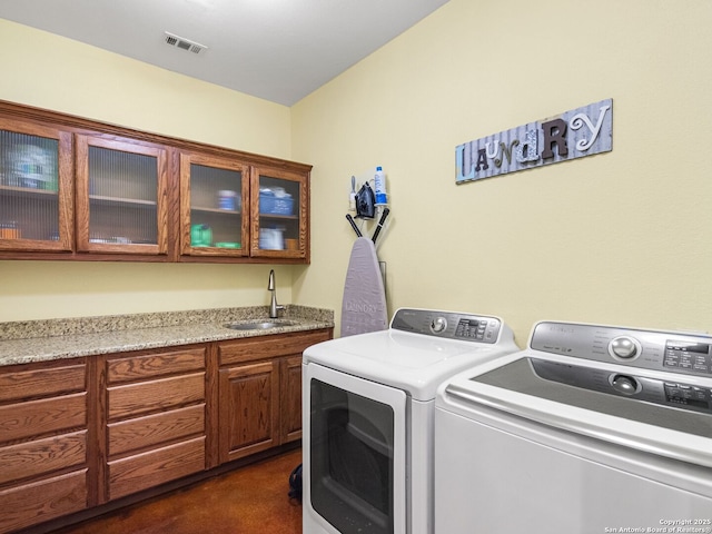 1131 Meadow Stream Rd, Spring Branch, TX 78070 - laundry room featuring washing machine and clothes dryer and cabinet space