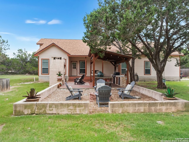1131 Meadow Stream Rd, Spring Branch, TX 78070 - back of property with an outdoor fire pit, a patio area, a lawn, and a shingled roof