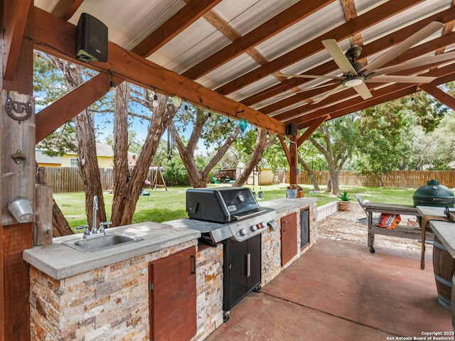 1131 Meadow Stream Rd, Spring Branch, TX 78070 - fenced backyard with exterior kitchen, a playground, ceiling fan, and a patio area