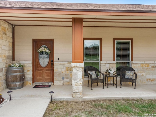 1131 Meadow Stream Rd, Spring Branch, TX 78070 - entrance to property featuring stone siding, a shingled roof, and covered porch