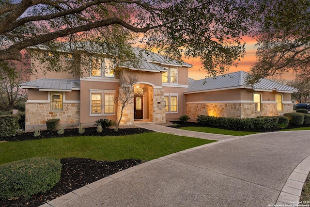 6 Champions Way, San Antonio, TX 78258 - view of front of house featuring stone siding, stucco siding, a front lawn, and a standing seam roof