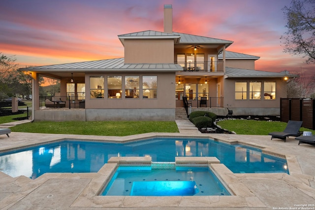 6 Champions Way, San Antonio, TX 78258 - back of house at dusk with a standing seam roof, a metal roof, a ceiling fan, and a balcony