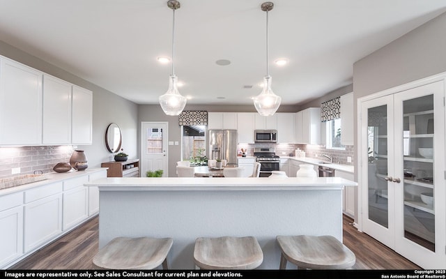 14704 Lower Holw, San Antonio, TX 78252 - kitchen with appliances with stainless steel finishes, decorative backsplash, a center island, white cabinetry, and recessed lighting