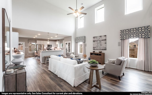 14704 Lower Holw, San Antonio, TX 78252 - living area with dark wood finished floors, a ceiling fan, and a high ceiling