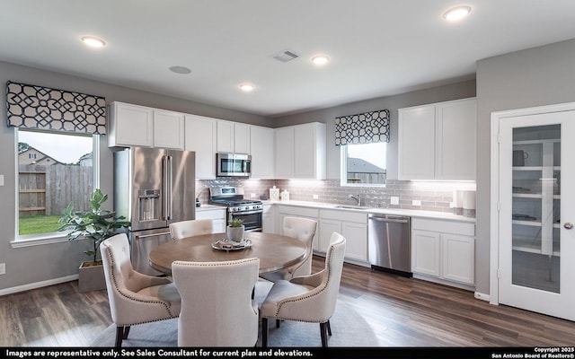 14704 Lower Holw, San Antonio, TX 78252 - kitchen featuring stainless steel appliances, white cabinets, decorative backsplash, and recessed lighting