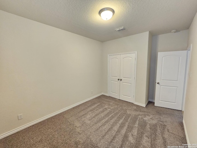 6723 Luckey Pond, San Antonio, TX 78252 - unfurnished bedroom featuring a textured ceiling, carpet floors, and a closet