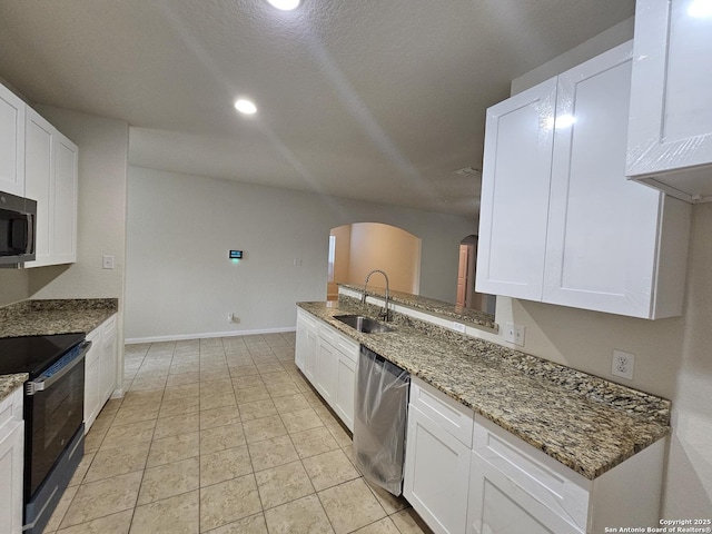 6723 Luckey Pond, San Antonio, TX 78252 - kitchen featuring stainless steel appliances, arched walkways, white cabinets, light stone countertops, and recessed lighting