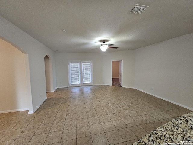6723 Luckey Pond, San Antonio, TX 78252 - spare room featuring a ceiling fan, arched walkways, and light tile patterned floors