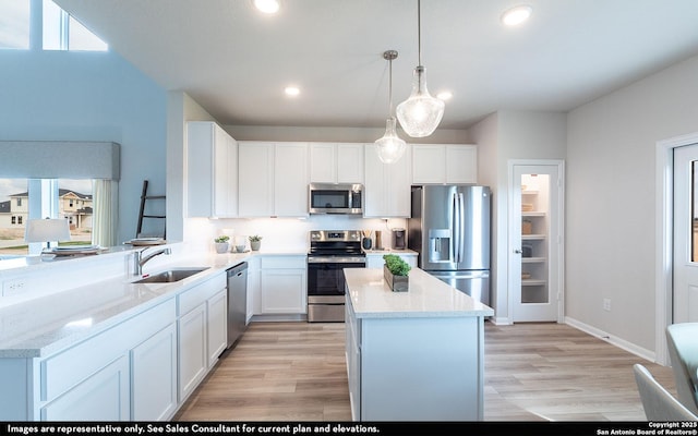 14732 Sycamore Xing, San Antonio, TX 78252 - kitchen with appliances with stainless steel finishes, a center island, white cabinets, and recessed lighting