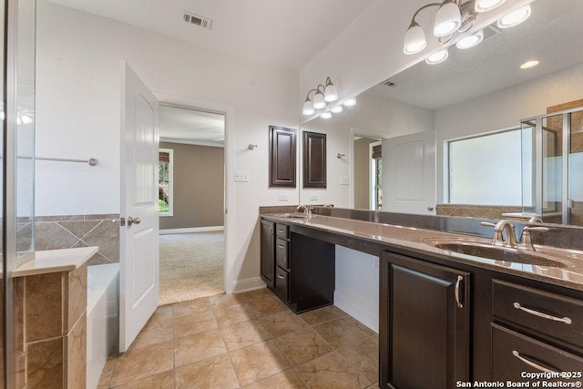 120 Red Bud, Boerne, TX 78006 - bathroom with double vanity, a chandelier, a garden tub, tile patterned flooring, and a shower with door