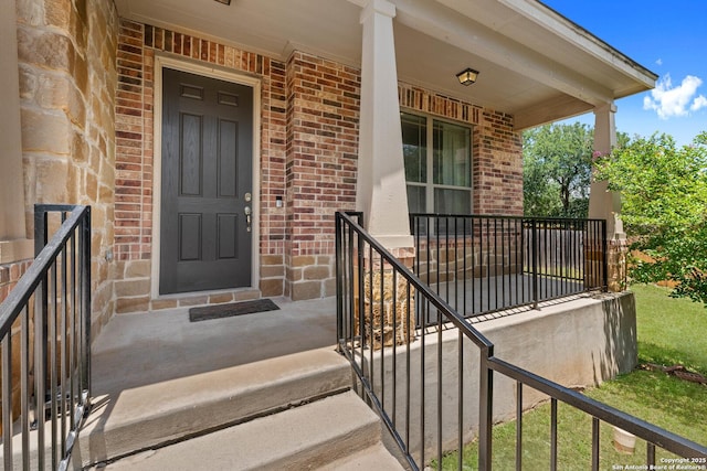 120 Red Bud, Boerne, TX 78006 - doorway to property with brick siding and covered porch