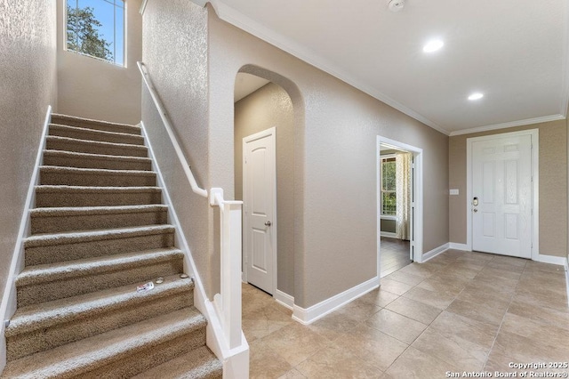 120 Red Bud, Boerne, TX 78006 - foyer with crown molding, arched walkways, stairs, light tile patterned floors, and recessed lighting