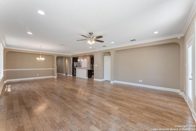 120 Red Bud, Boerne, TX 78006 - unfurnished living room with arched walkways, a ceiling fan, light wood-style floors, crown molding, and recessed lighting