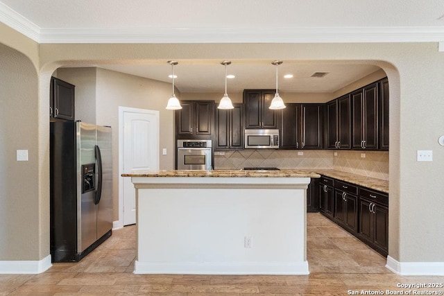 120 Red Bud, Boerne, TX 78006 - kitchen with appliances with stainless steel finishes, tasteful backsplash, light stone counters, a kitchen island, and ornamental molding