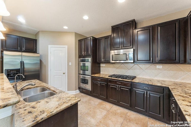 120 Red Bud, Boerne, TX 78006 - kitchen with appliances with stainless steel finishes, light stone counters, tasteful backsplash, and recessed lighting