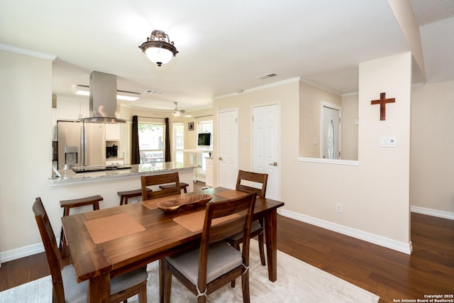 10707 Lake Path, San Antonio, TX 78217 - dining area featuring dark wood-type flooring and crown molding