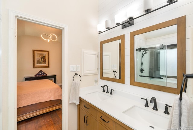 10707 Lake Path, San Antonio, TX 78217 - ensuite bathroom featuring double vanity, wood finished floors, and a shower with door
