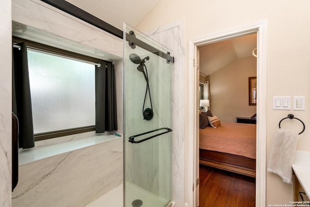 10707 Lake Path, San Antonio, TX 78217 - ensuite bathroom with vaulted ceiling, a marble finish shower, wood finished floors, and vanity