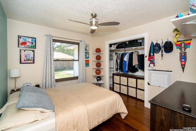 10707 Lake Path, San Antonio, TX 78217 - bedroom with dark wood finished floors, a closet, a textured ceiling, and ceiling fan