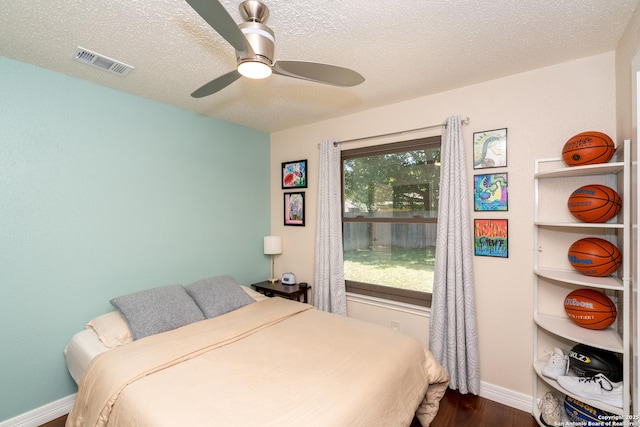 10707 Lake Path, San Antonio, TX 78217 - bedroom with dark wood-style floors, a textured ceiling, and ceiling fan