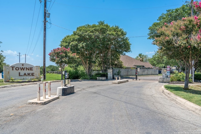 10707 Lake Path, San Antonio, TX 78217 - view of asphalt street with curbs, a gated entry, and a gate