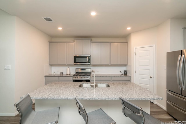 4951 Ranahan Pass, Saint Hedwig, TX 78152 - kitchen featuring stainless steel appliances, gray cabinets, a breakfast bar area, and recessed lighting