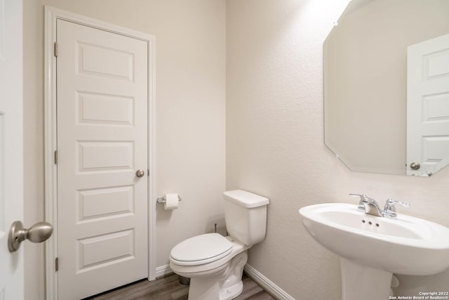4951 Ranahan Pass, Saint Hedwig, TX 78152 - half bathroom with wood finished floors and a sink