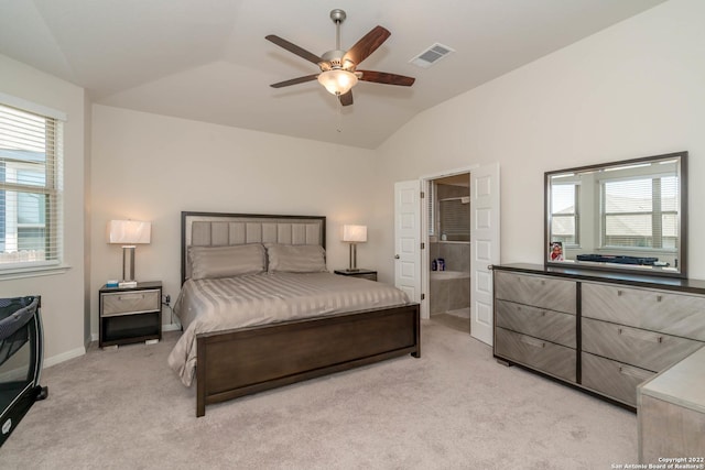 4951 Ranahan Pass, Saint Hedwig, TX 78152 - bedroom with vaulted ceiling, light carpet, multiple windows, a ceiling fan, and ensuite bath