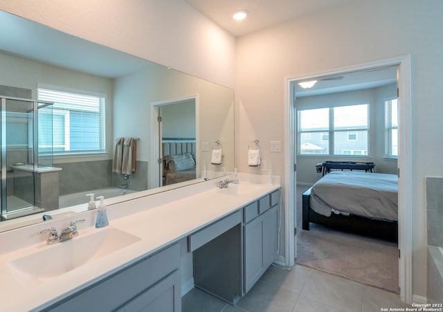 4951 Ranahan Pass, Saint Hedwig, TX 78152 - ensuite bathroom featuring a garden tub, tile patterned floors, a stall shower, double vanity, and plenty of natural light