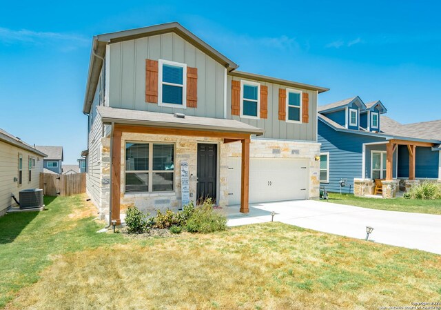 4951 Ranahan Pass, Saint Hedwig, TX 78152 - view of front of house featuring driveway, board and batten siding, a garage, and stone siding