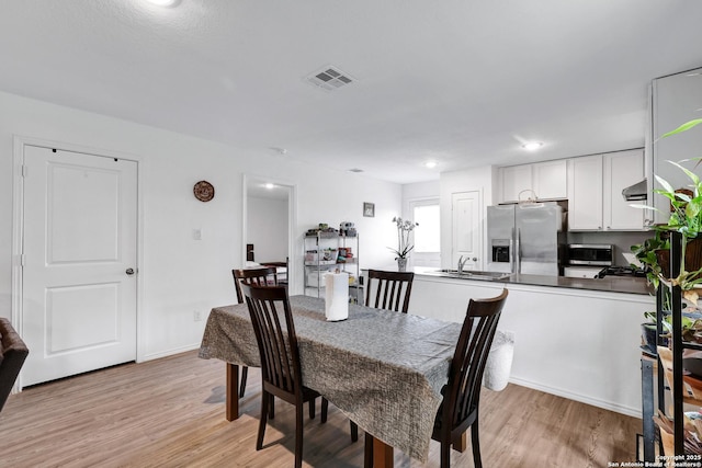 9015 Lunar Cv, San Antonio, TX 78252 - dining space with light wood finished floors
