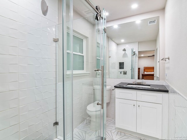 132 Wagon Trail Rd, Shavano Park, TX 78231 - bathroom with tile walls, vanity, a stall shower, recessed lighting, and ensuite bath