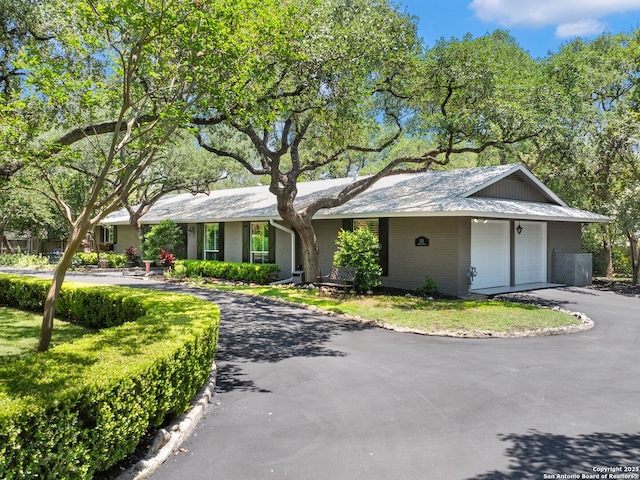 132 Wagon Trail Rd, Shavano Park, TX 78231 - ranch-style home with driveway, brick siding, and an attached garage