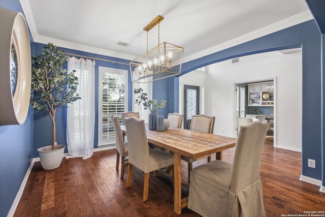 20907 Cactus Peak, San Antonio, TX 78258 - dining room featuring hardwood / wood-style flooring, ornamental molding, a chandelier, and arched walkways