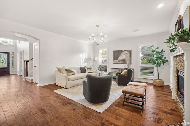 20907 Cactus Peak, San Antonio, TX 78258 - living room with a glass covered fireplace, arched walkways, a chandelier, wood finished floors, and ornamental molding