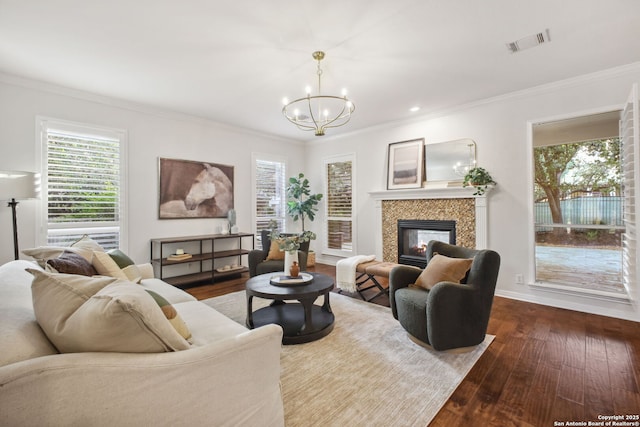 20907 Cactus Peak, San Antonio, TX 78258 - living room featuring wood-type flooring, crown molding, a chandelier, a multi sided fireplace, and healthy amount of natural light