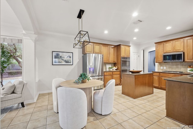 20907 Cactus Peak, San Antonio, TX 78258 - kitchen featuring stainless steel appliances, a center island, light tile patterned floors, arched walkways, and backsplash