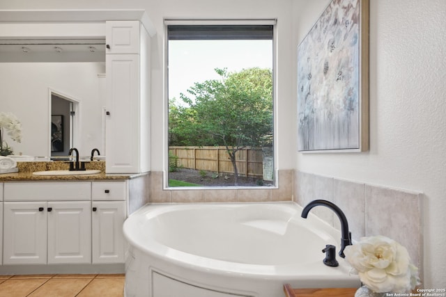 20907 Cactus Peak, San Antonio, TX 78258 - full bath featuring healthy amount of natural light, vanity, a garden tub, and tile patterned flooring