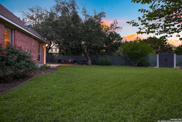 20907 Cactus Peak, San Antonio, TX 78258 - yard at dusk with a storage shed and a fenced backyard