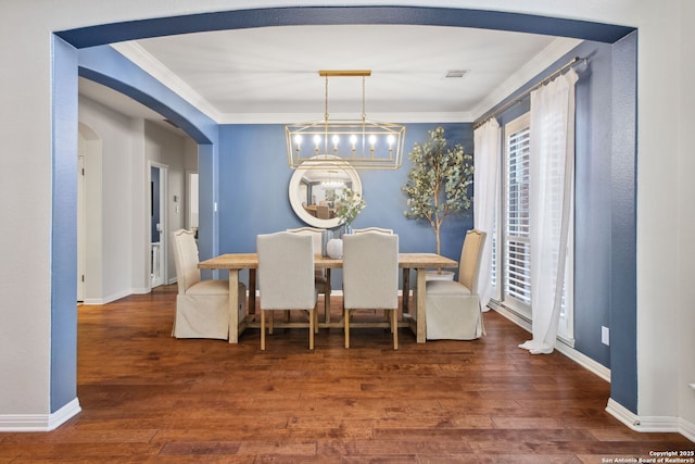 20907 Cactus Peak, San Antonio, TX 78258 - dining area with ornamental molding, arched walkways, wood finished floors, and a chandelier