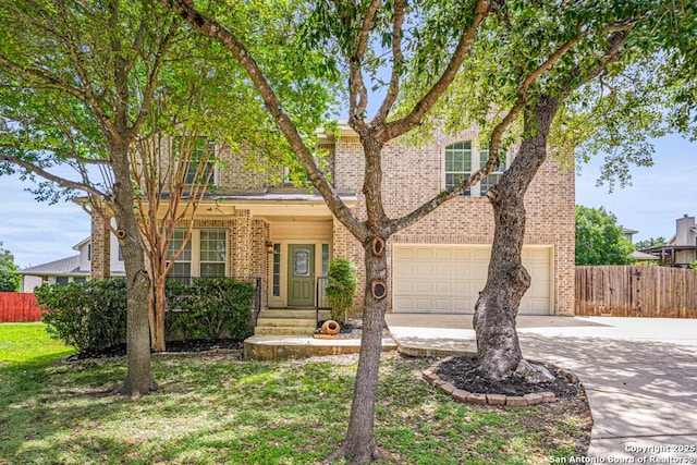 223 Verde Blf, San Antonio, TX 78258 - view of front facade with driveway, brick siding, and an attached garage