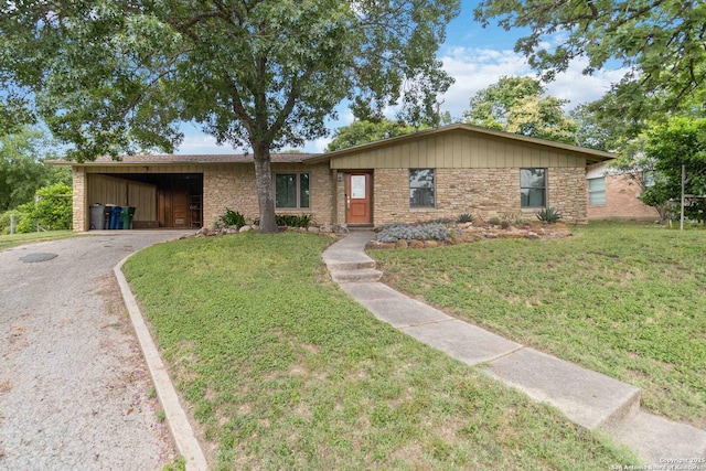 4722 Hollyridge, San Antonio, TX 78228 - view of front of property with asphalt driveway, an attached carport, a front yard, and stone siding