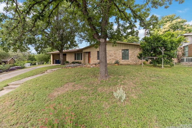 4722 Hollyridge, San Antonio, TX 78228 - view of front of property featuring concrete driveway, a garage, a front yard, and stone siding